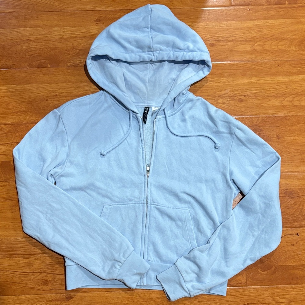 Used divided light blue zip up jacket size M